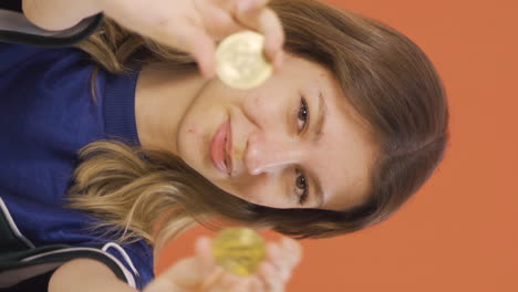 Vertical-video-of-Young-woman-holding-bitcoin-and-showing-it.